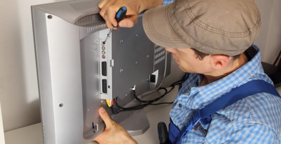 Electrician repairing a TV — Electricians in Warana QLD