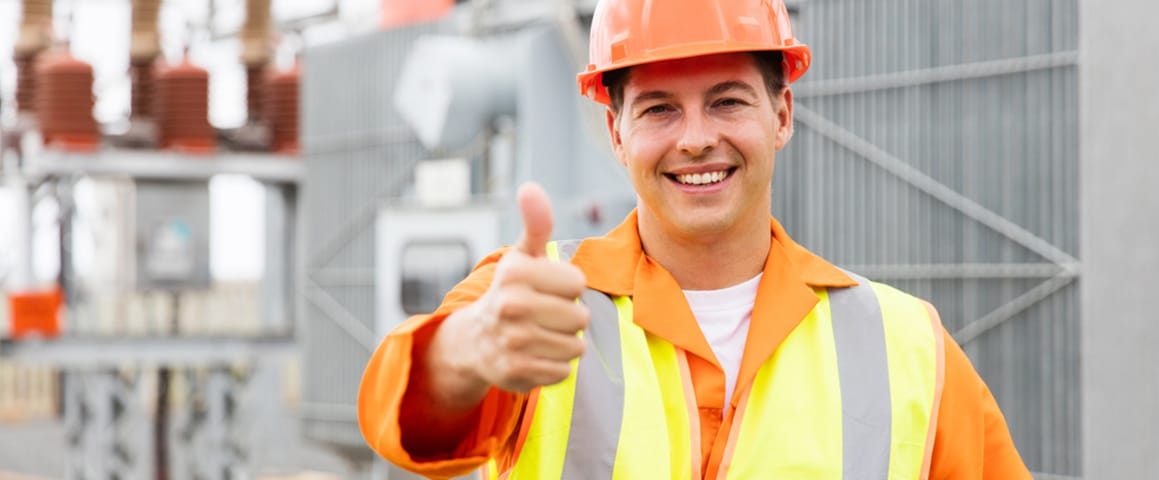 Electrician with thumb up at electric substation — Electricians Near Me in Warana QLD