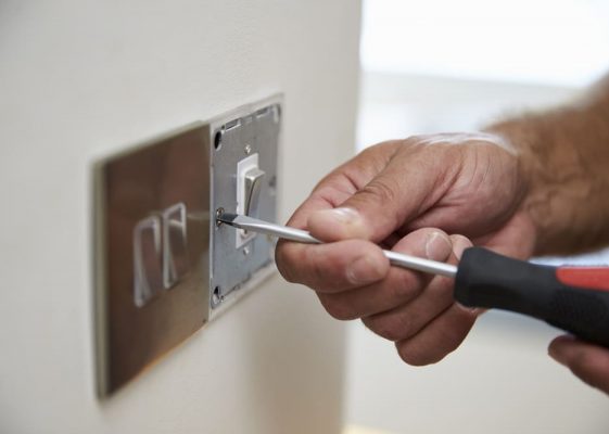 Close Up Of Electrician Repairing Domestic Light Switch — Electricians Near Me in Warana QLD