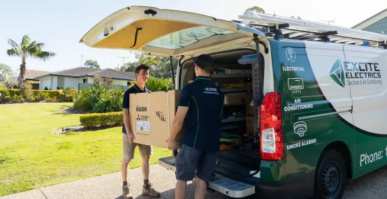Two Sunshine Coast Electricians moving electrical parts from van