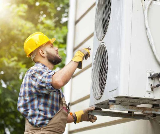 Male Technician Repairing Air Conditioner
