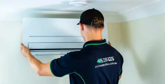 Worker adding air condition — Electrician Sunshine Coast QLD